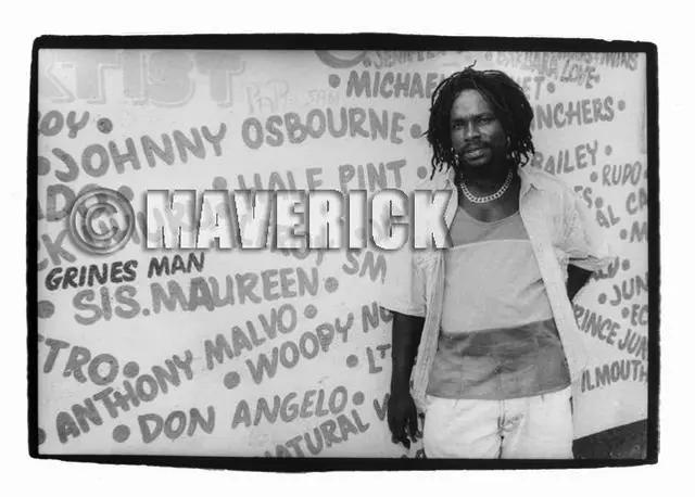 Johnny Osbourne cutting a pose against the 'wall of fame' outside Jammy's studio in Waterhouse